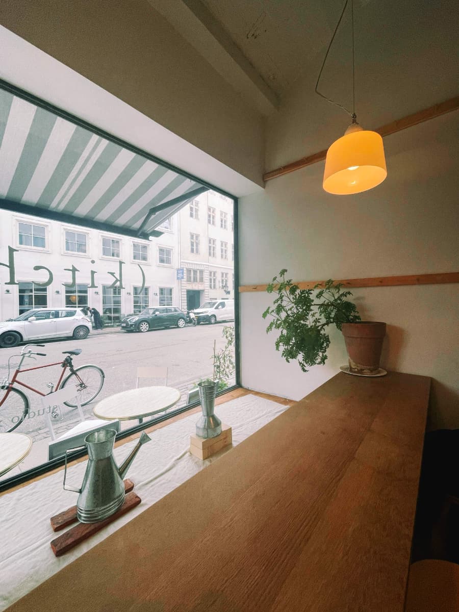 Beautiful cafe with a bike parked outside.