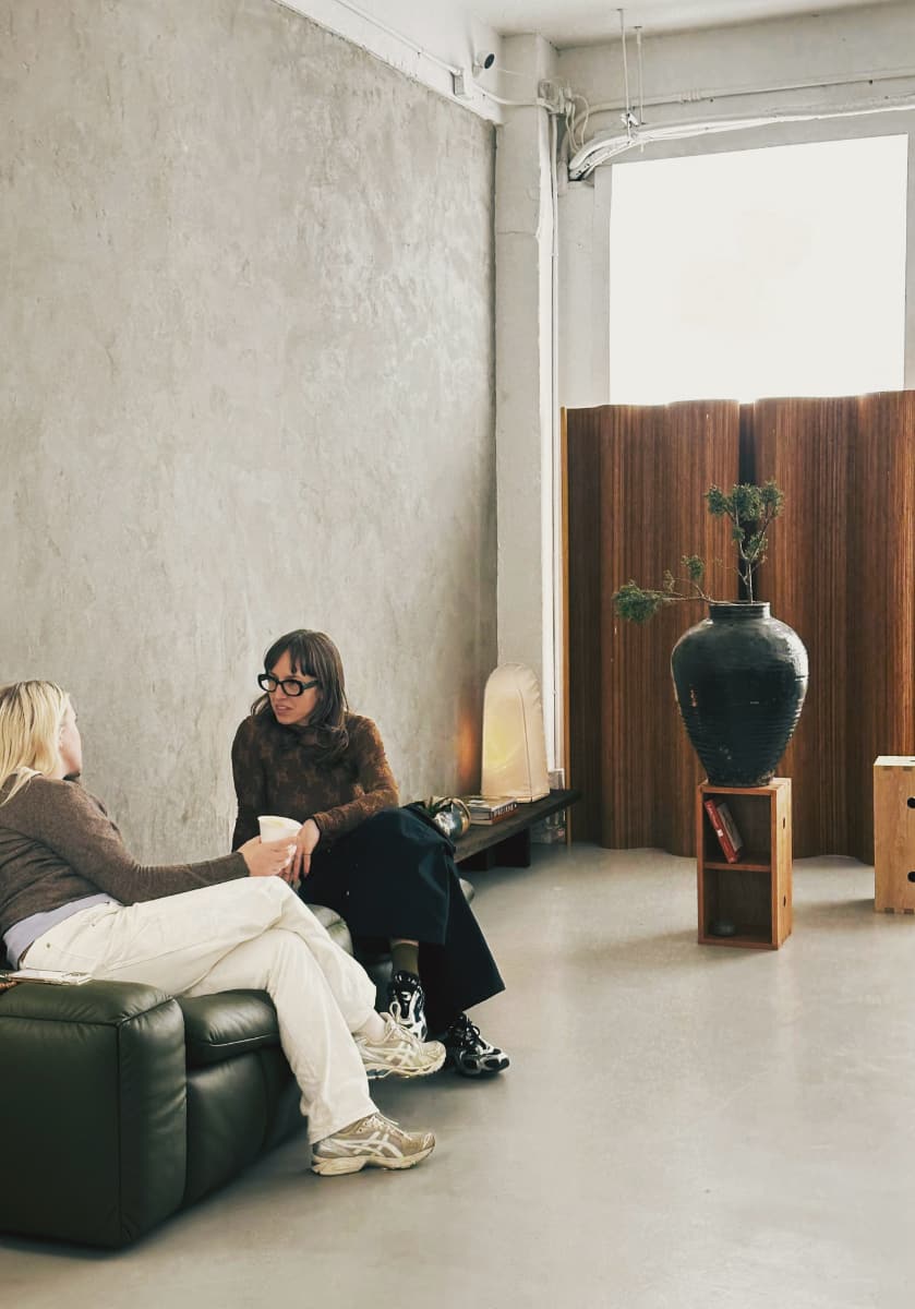 People chatting in stylish room.